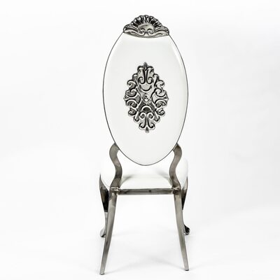 Rear view of silver chair with white oval backrest and an ornate scrolled silver medallion beneath a shell-shaped crest