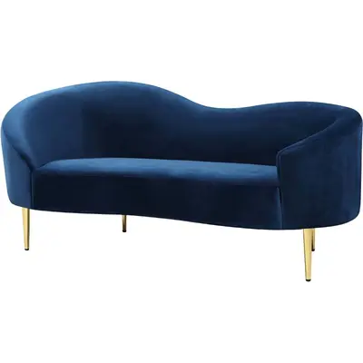 Navy blue suede curved loveseat with slim gold legs, shown at a three-quarter angle