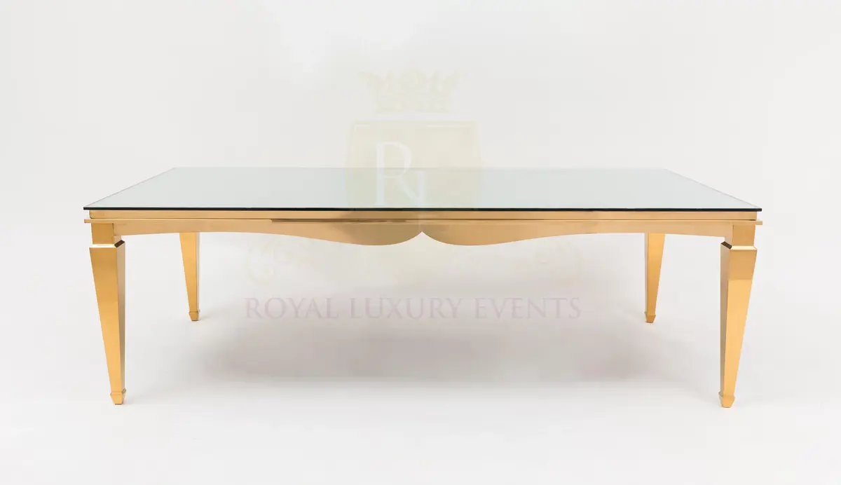 Polished gold rectangular table with a glass top and tapered legs