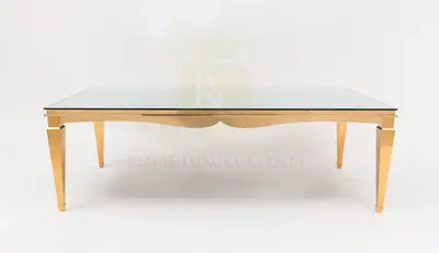 Rectangular table with a glass top and polished gold tapered legs