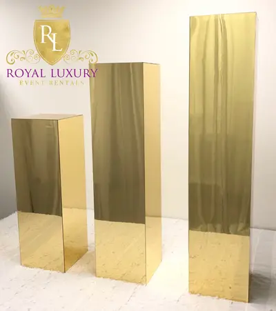 Set of three gold mirrored flower stands in graduated heights, shown empty
