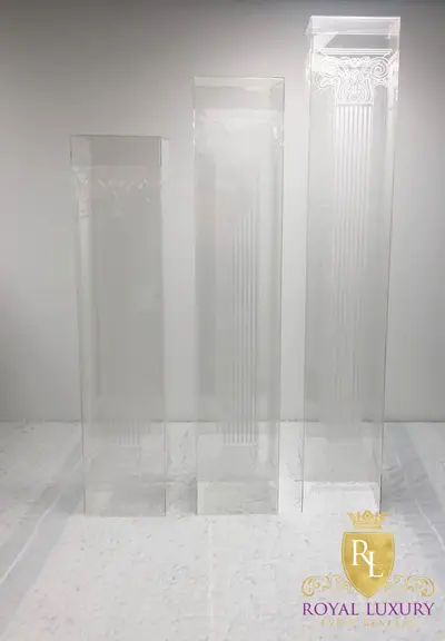Three clear acrylic flower stands in graduated heights with subtle white engraved column details and no gold or black accents