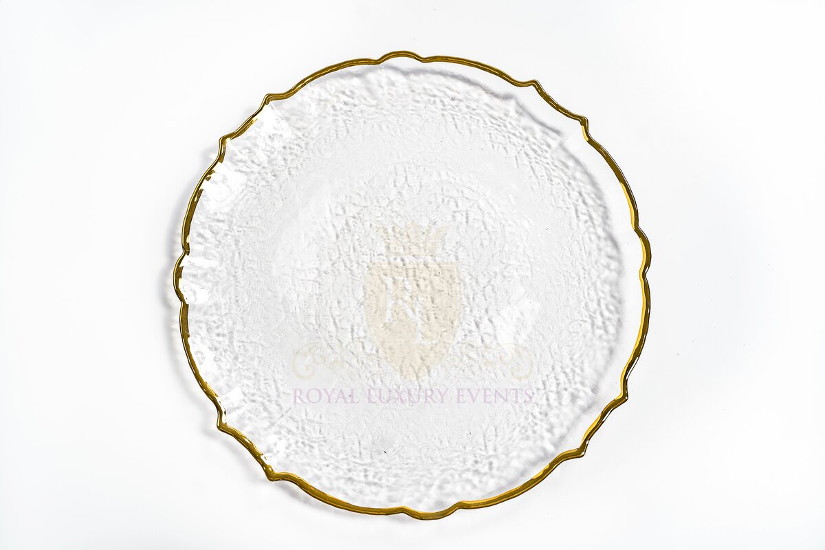 Clear glass charger plate with a scalloped seashell edge, gold rim and textured surface, shown from above