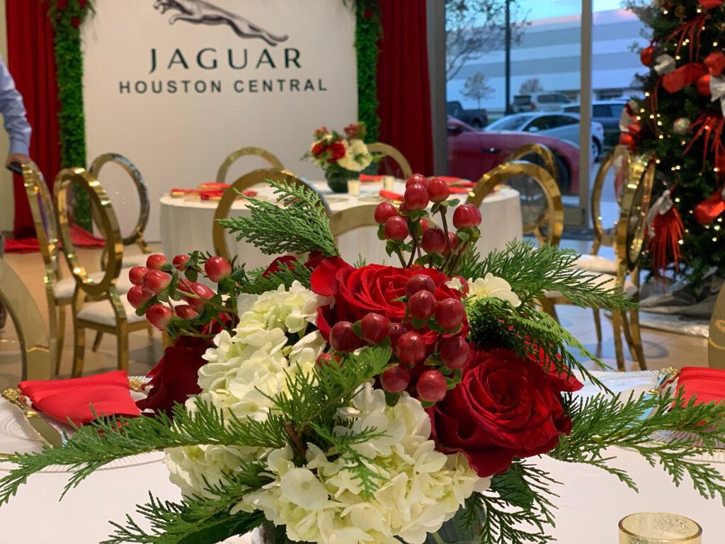 jaguar holiday party with red and white flowers