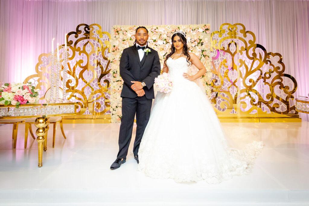 Balqees and Terrance had their gold and white wedding at the Bell Tower on 34th, featuring gorgeous ceiling decor and a stunning sweetheart table display.