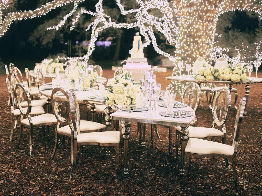 outdoor reception - lights - silver teardrop table - wedding cake table - sweetheart table