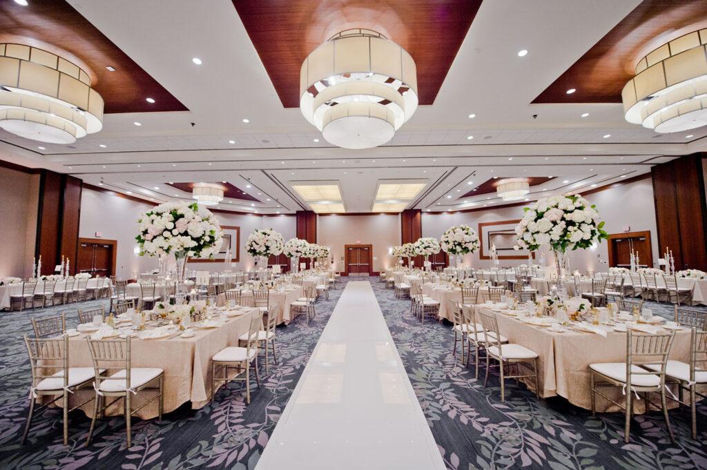 wedding reception decor featured gorgeous tall centerpieces in clear vases, crystal candle holders, pearl charger plates and a stunning sweetheart table.