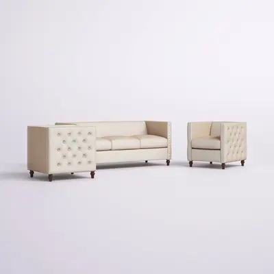 Beige tufted sofa beside two matching tufted armchairs with nailhead trim, shown as a lounge grouping