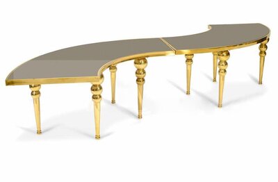 S-shaped table in two sections with gold frame, gold bubble legs and a dark mirrored top, shown from above