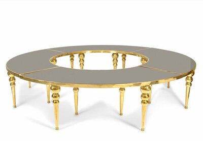 Four table quarters joined into a circle with a round opening in the middle, gold frame and bubble legs