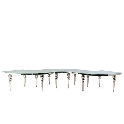 Three silver serpentine table sections joined in an S-shape, with polished bubble legs and a glass top