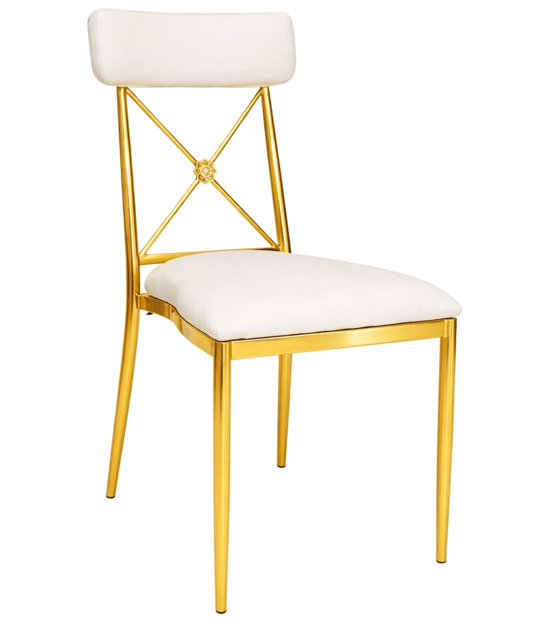 Gold cross-back dining chair with white velvet seat and back cushion, shown at a three-quarter angle on white