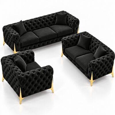 Black tufted velvet lounge set with gold legs: three-seater sofa, two-seater sofa and armchair on white