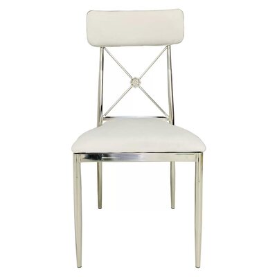 Front view of a silver cross-back chair with white velvet seat and back cushion