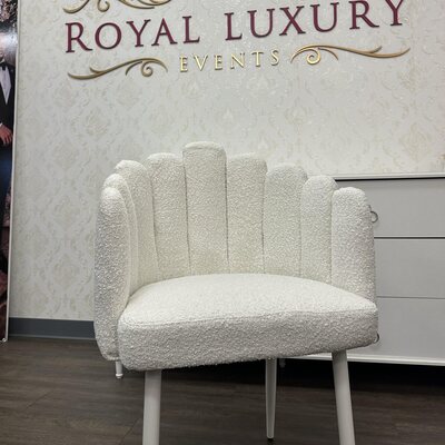 White scalloped chair with textured boucle upholstery and slim white legs