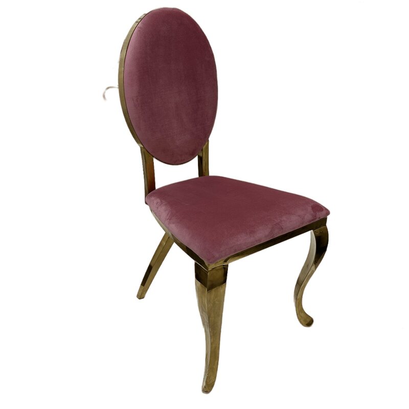 Gold chair with oval back and pink velvet cushions, shown at an angle
