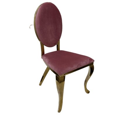 Gold chair with oval pink velvet back and seat on curved gold legs, angled view