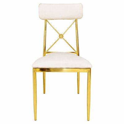 Gold cross-back dining chair with white cushions and a small floral medallion, shown straight from the front