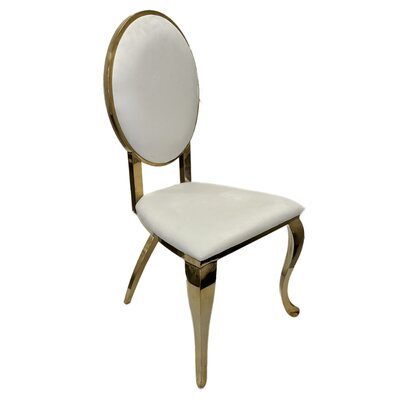 Gold chair with oval back and white cushions, shown at an angle