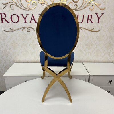 Rear view of gold chair with navy velvet back, showing the crossed gold legs and oval frame