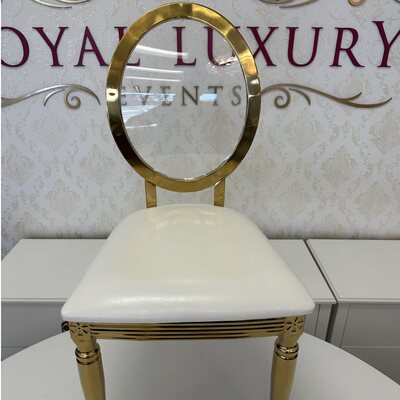Gold dining chair with oval clear acrylic back and white seat cushion, front view with fluted legs