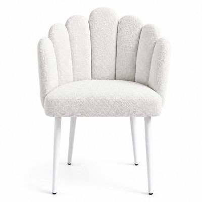 White scalloped chair with textured boucle upholstery and slim white legs