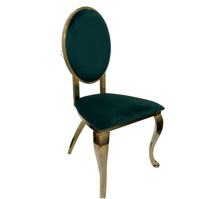 Gold cross leg chair with oval emerald green velvet back and seat, shown at a three-quarter angle